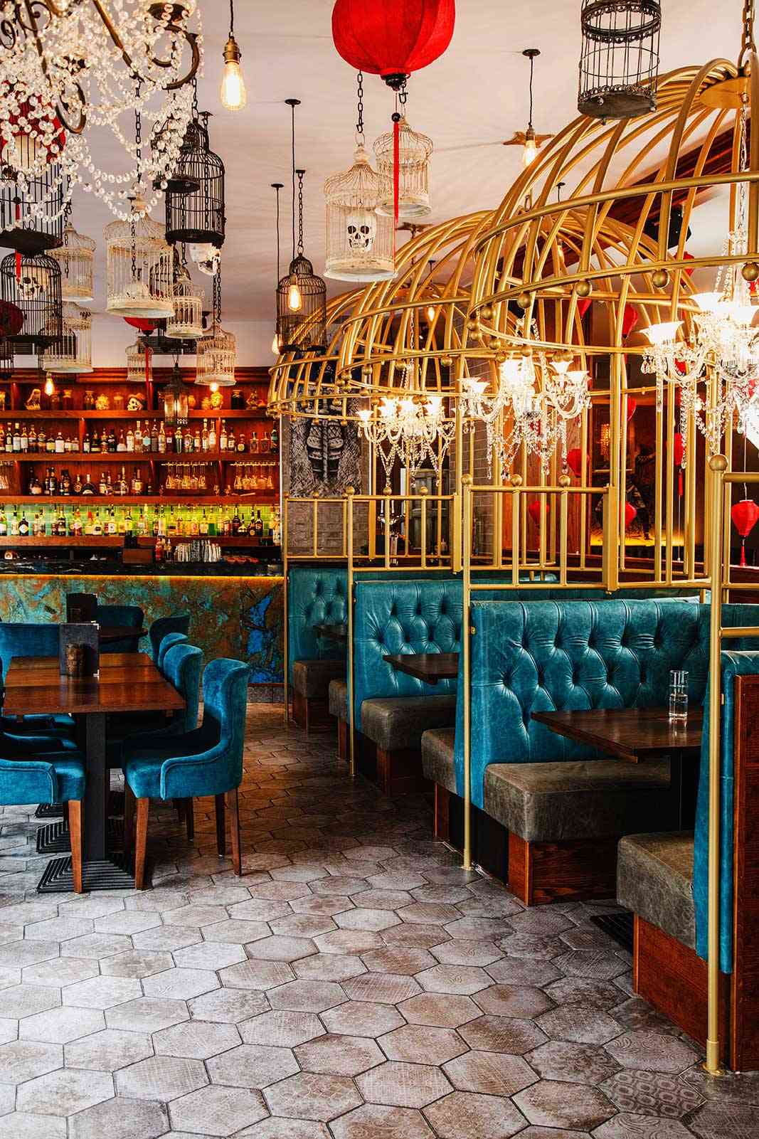 A row of gold birdcage booths and red lanterns at Siamais Birmingham